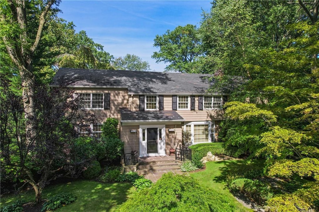 colonial home with a front lawn