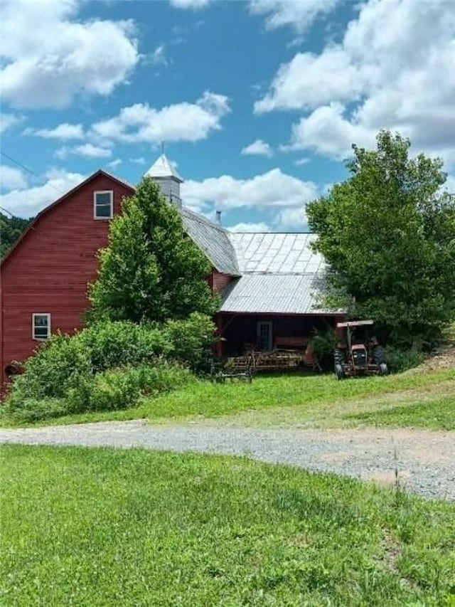 view of home's exterior featuring an outbuilding and a yard