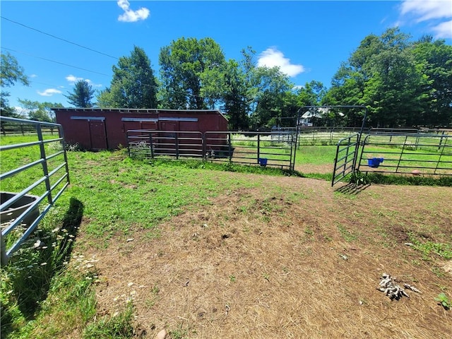 view of yard with an outbuilding and a rural view