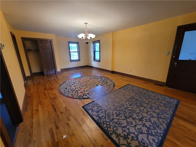 foyer featuring a chandelier and wood-type flooring