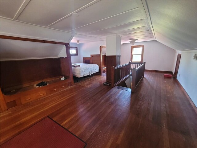 unfurnished bedroom featuring dark wood-type flooring and vaulted ceiling