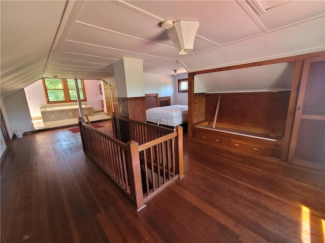 bedroom with vaulted ceiling and dark hardwood / wood-style floors