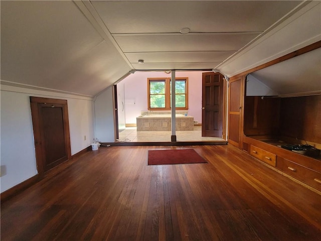 bonus room with hardwood / wood-style floors and vaulted ceiling