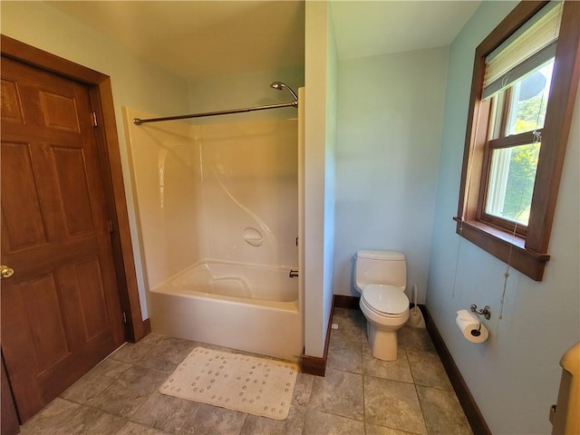 bathroom with toilet and washtub / shower combination