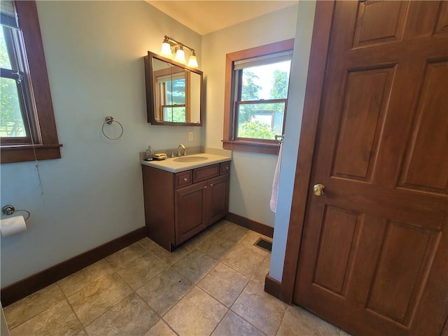 bathroom with tile patterned flooring and vanity