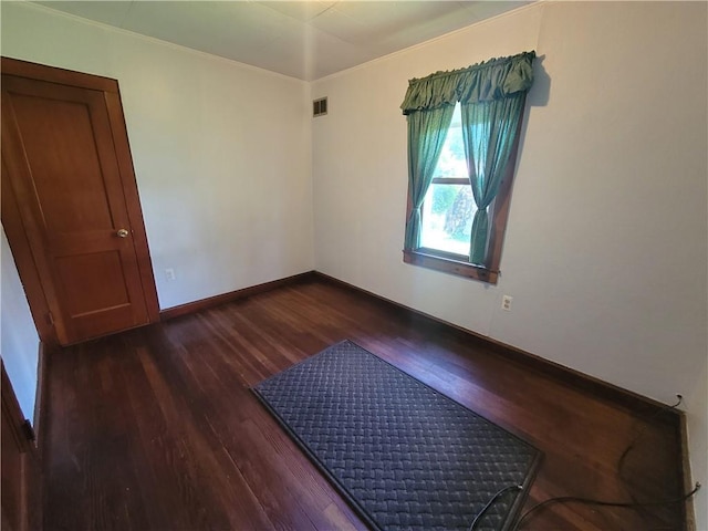 empty room with dark hardwood / wood-style flooring