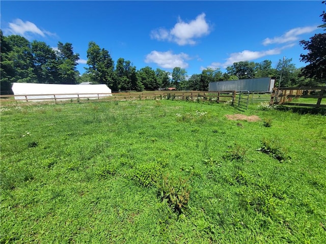 view of yard with a rural view and an outdoor structure