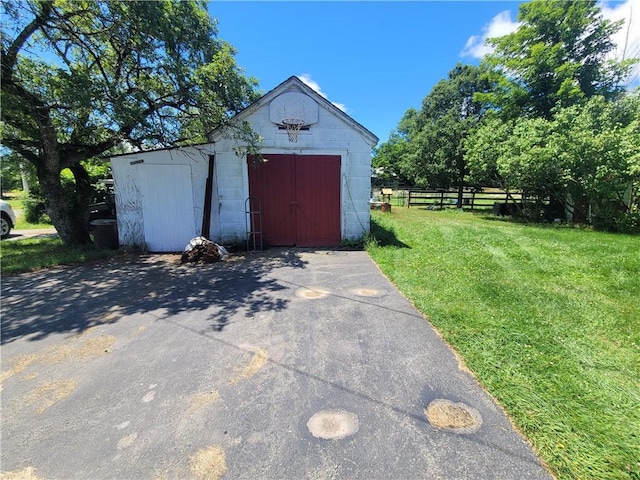 view of outdoor structure featuring a lawn