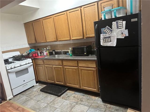 kitchen with sink, backsplash, and black appliances