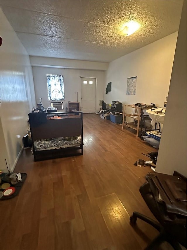 bedroom featuring wood-type flooring and a textured ceiling