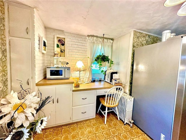 office area featuring radiator and built in desk