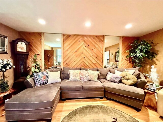 living room featuring wood walls and light hardwood / wood-style flooring