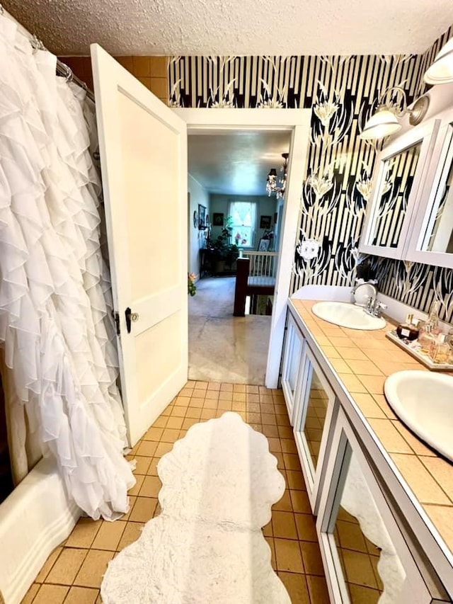 5090 State Route 52, Jeffersonville, NY 12748 - bathroom with double vanity, tile patterned floors, shower / bath combo with shower curtain, and a textured ceiling