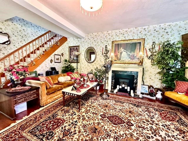 5090 State Route 52, Jeffersonville, NY 12748 - living room with wallpapered walls, stairway, a high end fireplace, and wood finished floors