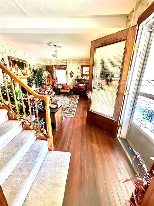 5090 State Route 52, Jeffersonville, NY 12748 - entryway featuring dark wood-style flooring, stairway, wallpapered walls, and beamed ceiling