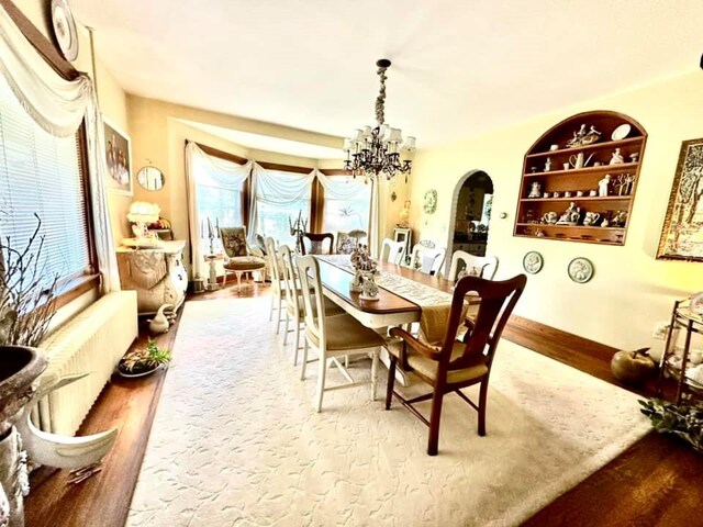 dining room with a chandelier and wood-type flooring