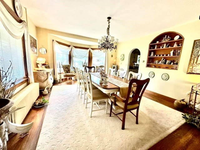 5090 State Route 52, Jeffersonville, NY 12748 - dining space featuring arched walkways, wood finished floors, plenty of natural light, and a chandelier
