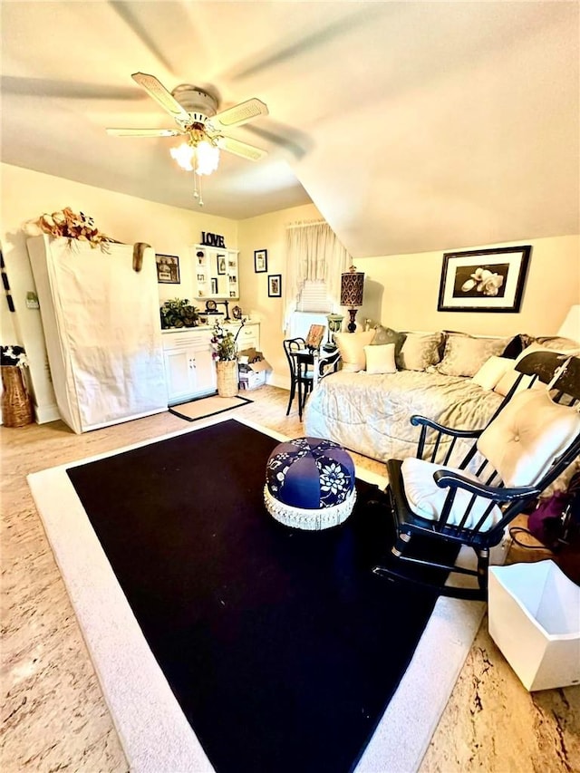 interior space featuring ceiling fan and lofted ceiling