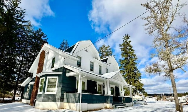 view of snow covered exterior with covered porch