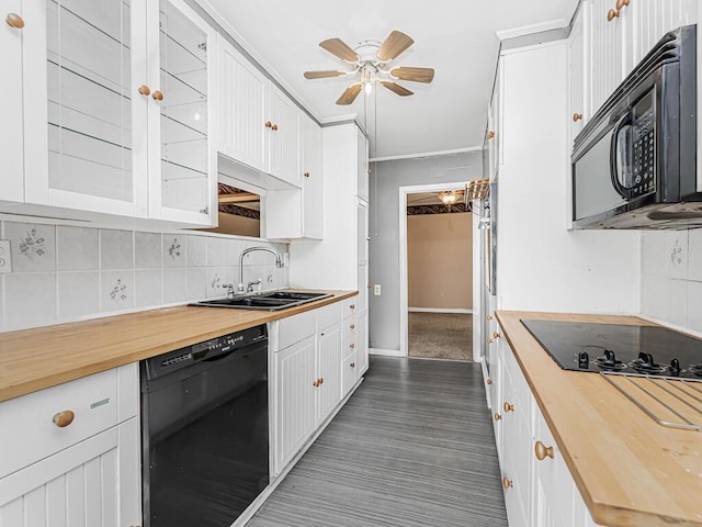 kitchen with wooden counters, black appliances, sink, tasteful backsplash, and white cabinetry