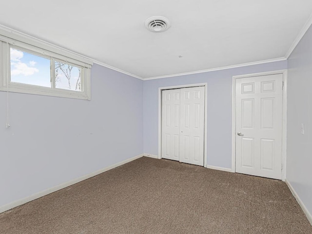 unfurnished bedroom with carpet floors and crown molding