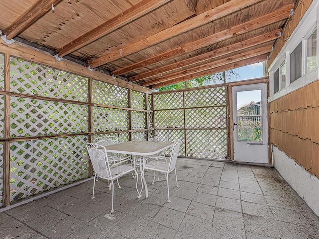 unfurnished sunroom with lofted ceiling