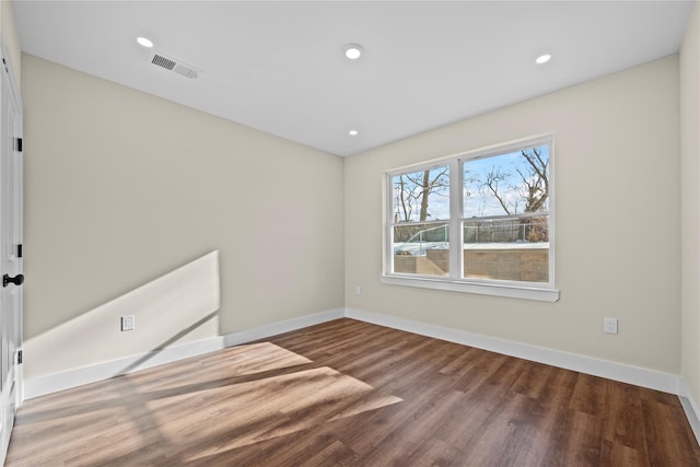 unfurnished room with hardwood / wood-style flooring