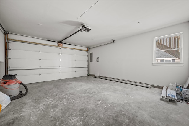 garage with a garage door opener and electric panel