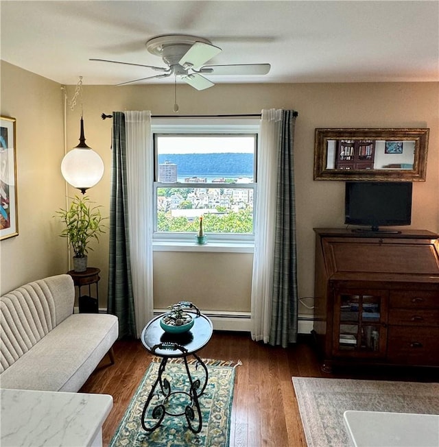 sitting room featuring ceiling fan and dark hardwood / wood-style flooring