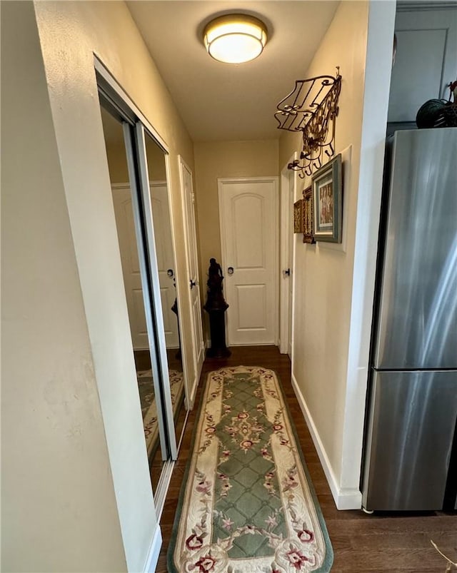 hallway with dark hardwood / wood-style flooring