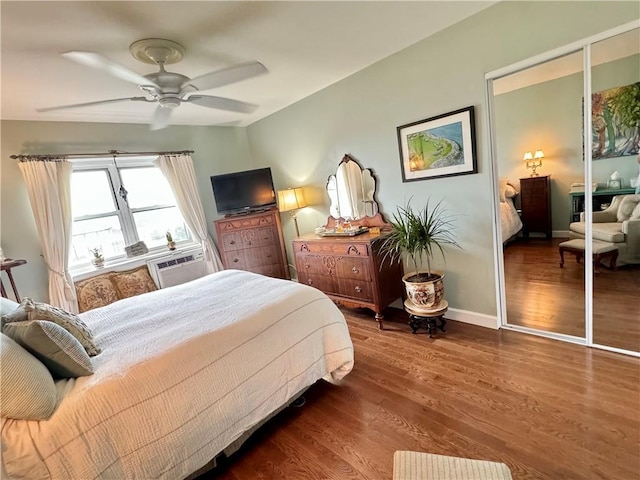 bedroom with ceiling fan, wood-type flooring, and a closet