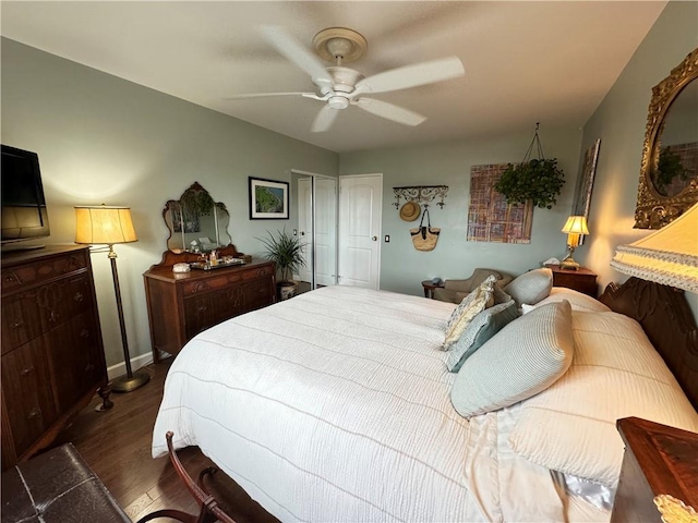 bedroom featuring a closet, dark hardwood / wood-style floors, and ceiling fan