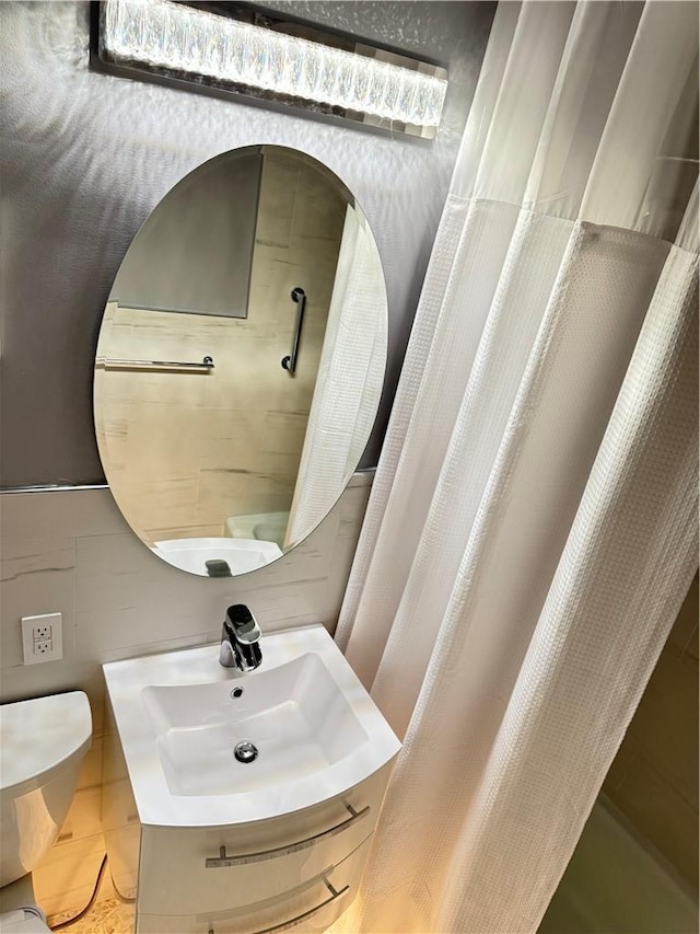 bathroom featuring tile patterned flooring, vanity, and toilet