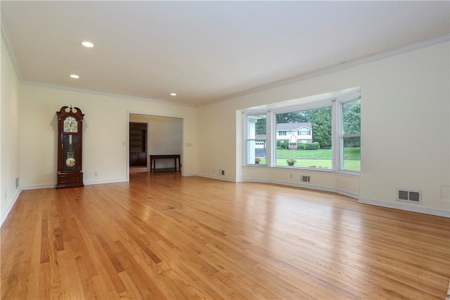 unfurnished living room with ornamental molding and light hardwood / wood-style flooring