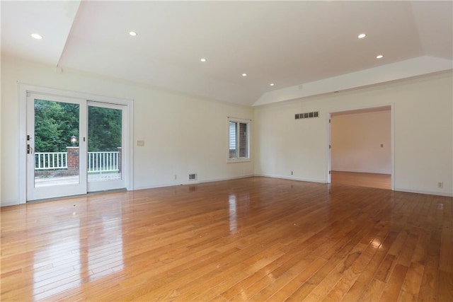 unfurnished room featuring light hardwood / wood-style flooring and lofted ceiling