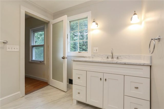 bathroom with vanity and ornamental molding