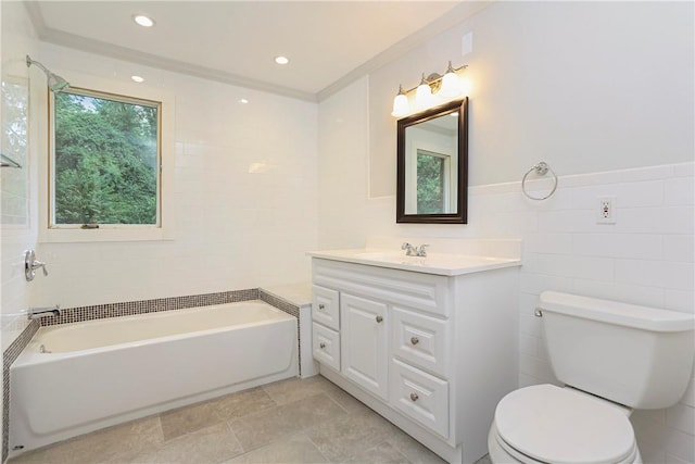 bathroom with vanity, a tub to relax in, toilet, and tile walls