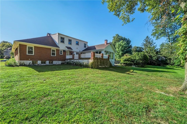 rear view of property with a yard