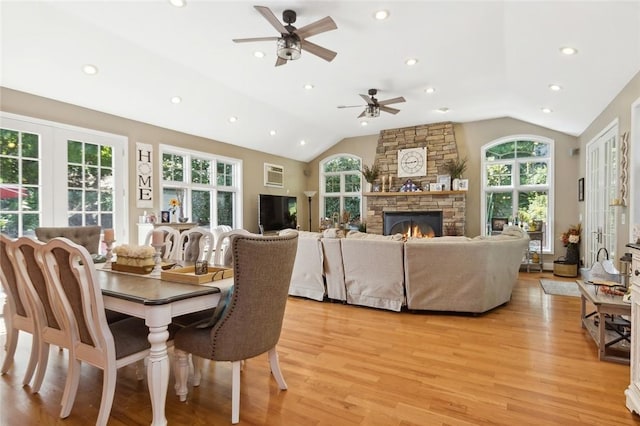 dining area with a healthy amount of sunlight, lofted ceiling, and light hardwood / wood-style floors