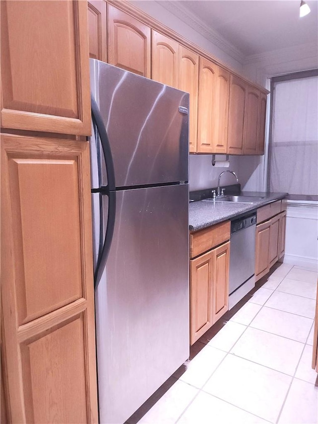 kitchen featuring light tile patterned flooring, ornamental molding, sink, and appliances with stainless steel finishes