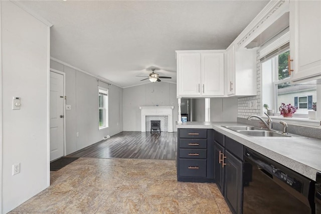 kitchen with white cabinets, light wood-type flooring, dishwasher, and sink