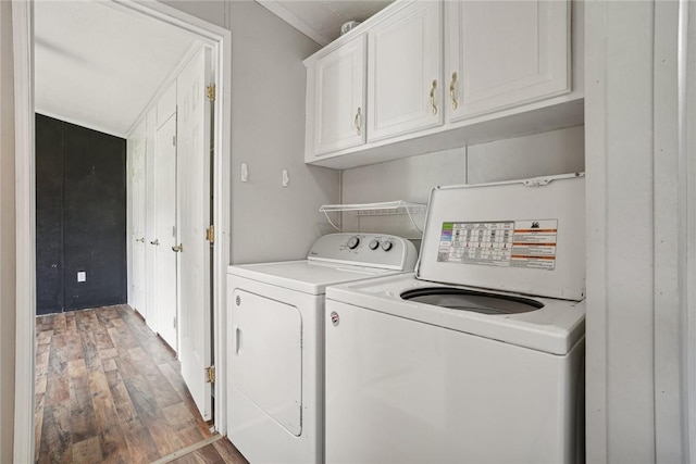 laundry area with cabinets, dark hardwood / wood-style flooring, and independent washer and dryer