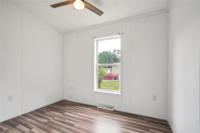 spare room featuring hardwood / wood-style floors, ceiling fan, and ornamental molding