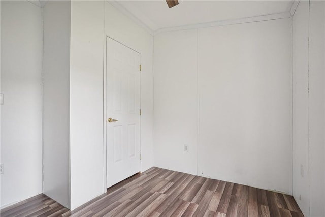 unfurnished room with hardwood / wood-style flooring and crown molding