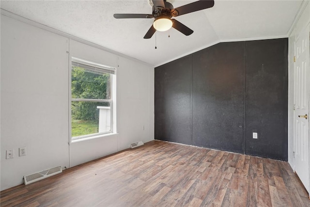 unfurnished room featuring hardwood / wood-style flooring, vaulted ceiling, and ceiling fan