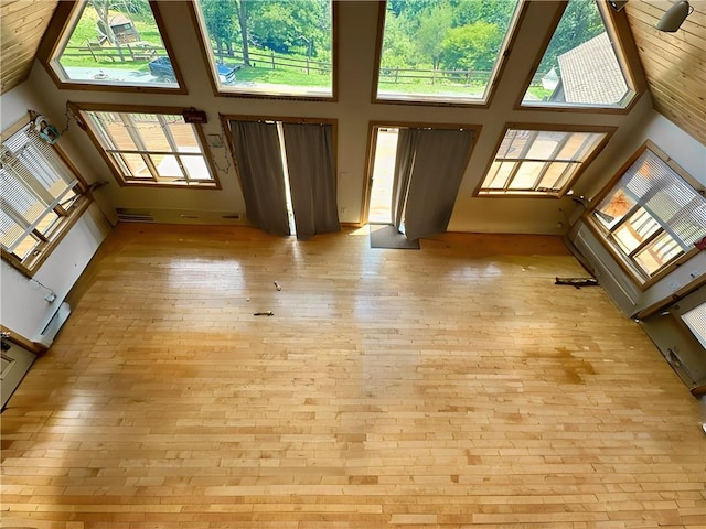 unfurnished living room with a towering ceiling