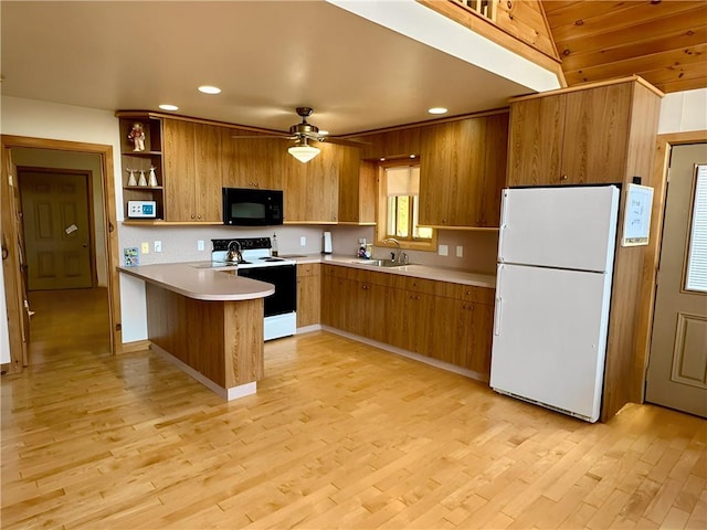 kitchen featuring sink, light wood-type flooring, range with electric stovetop, kitchen peninsula, and white fridge