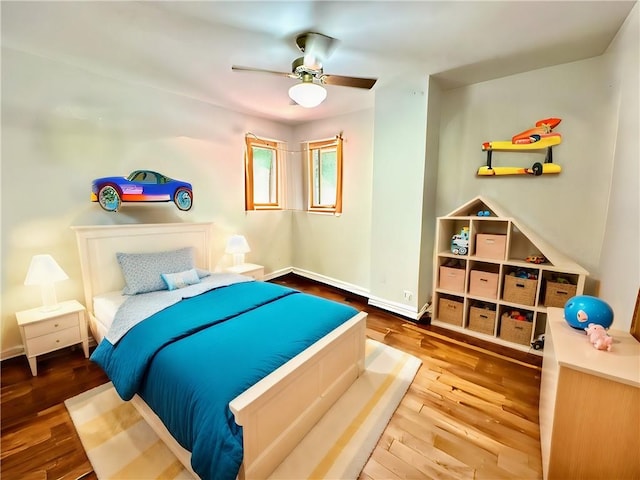 bedroom with ceiling fan and wood-type flooring