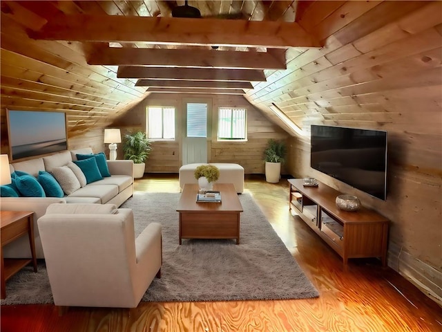 additional living space with hardwood / wood-style flooring, lofted ceiling, and wood walls