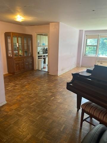 miscellaneous room with dark parquet flooring